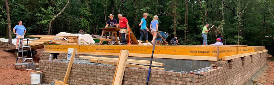 Volunteers building foundation of home for Habitat for Humanity on REALTORS Give Back Day